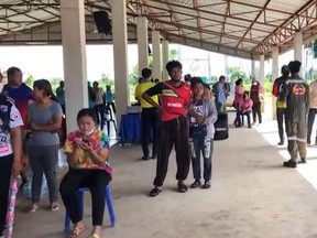 This frame grab from video footage by Thai PBS made available via AFPTV and taken on Thursday, Oct. 6, 2022, shows people gathering in the northern Thai province of Nong Bua Lam Phu, where a former policeman shot dead more than 30 people in a nursery.