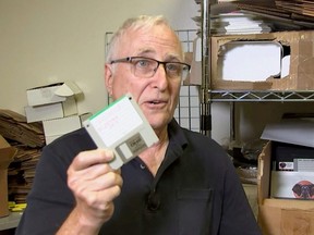 Tom Persky, owner of floppydisk.com and a disk trader, shows off a 3.5-inch computer disk at his warehouse in Lake Forest, California, Oct. 6, 2022 in this screengrab from a Reuters TV video.