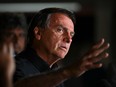 Brazilian President and re-election candidate Jair Bolsonaro speaks after learning the results of the legislative and presidential election in Brasilia, on Oct. 2, 2022.