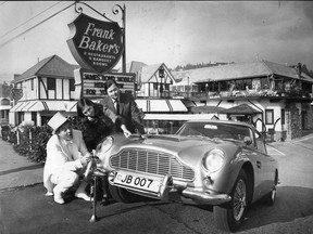 Restauranteur Frank Baker (L) and Mr. and Mrs. Sandy Luscombe-Whyte with the James Bond Aston Martin car in front of Baker's restaurant The Attic in West Vancouver in 1969. Baker bought the car from Luscombe-Whyte and displayed it in front of his restaurant. Story ran Province Nov 1969. Bill Cunningham/The Province