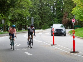 A car and a pair of cyclists in their lanes in Stanley Park in May, 2022. The new ABC majority on park board will return the bike lane to vehicle traffic.
