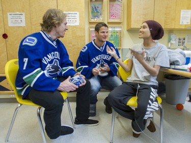 Ashley Chen meets David Booth (left) and Kevin Bieksa during Vancouver Canucks' visit to BC Children's Hospital in Vancouver, BC, February 24, 2014.   (Arlen Redekop / PNG)