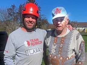 Chief Larry Watkinson of the Penticton Fire Department doing relief work in Nova Scotia with Charlie, 91, whose home was badly damaged by Storm Fiona.