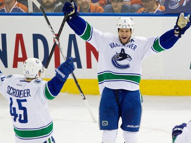 Vancouver Canucks' Kevin Bieksa celebrates his game-tying goal against the Edmonton Oilers with Jordan Schroeder during third period NHL action at Rexall Place in Edmonton, Alta. on Monday, Feb. 4, 2013. The Oilers lost 3-2 in overtime. Amber Bracken/Edmonton Sun/