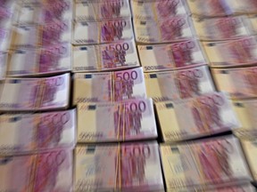 A picture taken on October 6, 2022 in Madrid shows counterfeit 500 euros banknotes.