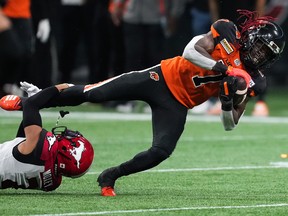 B.C. Lions’ Lucky Whitehead, right, is tackled by Calgary Stampeders’ Jonathan Moxey during the second half of CFL football game in Vancouver, on Saturday, September 24, 2022.