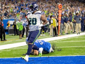 Seattle Seahawks running back Rashaad Penny (20) scores a touchdown against the Detroit Lions during the third quarter at Ford Field.