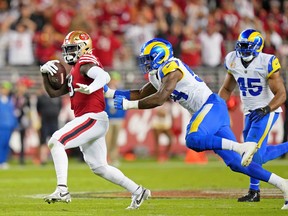 San Francisco 49ers wide receiver Deebo Samuel (19) runs with the ball as Los Angeles Rams linebacker Leonard Floyd (54) pursues during the fourth quarter at Levi's Stadium.