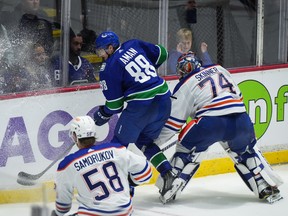 Canucks centre Nils Aman gets to the puck ahead of Edmonton Oilers goalie Stuart Skinner during the third period of Wednesday’s NHL pre-season game in Abbotsford.