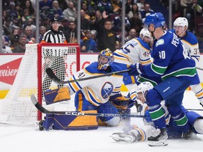 Craig Anderson denies Elias Pettersson during the first period Saturday at Rogers Arena.