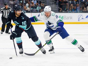 Slick centre Matty Beniers (left), the Seattle Kraken’s top draft pick in 2021, will test Curtis Lazar and the Canucks on Thursday at Climate Pledge Arena in Seattle.