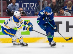 Canucks forward Ilya Mikheyev gets past Sabres defenceman Casey Fitzgerald in the first period Saturday at Rogers Arena.