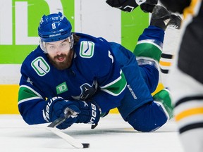 Canucks winger Conor Garland goes flat out to retrieve loose puck during Oct. 28 matchup against the Penguins at Rogers Arena.