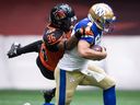 B.C. Lions' Quincy Mauger sacks Winnipeg Blue Bombers quarterback Zach Collaros during a CFL game in Vancouver last season. The two teams meet again Friday, with first place in the West on the line.