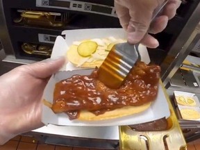 Screen shot of process of McDonald's McRib being made and assembled.