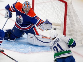 Edmonton Oilers goalie Jack Campbell (36) is scored on by Vancouver Canucks Nils Hoglander (21) during second period pre-season action on Monday, Oct. 3, 2022 in Edmonton.