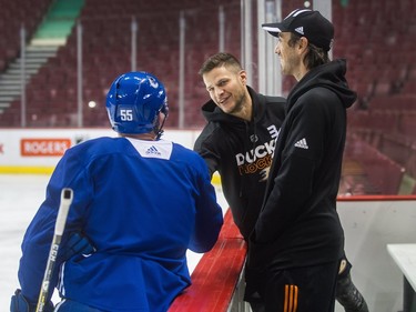 Anaheim Ducks Kevin Bieksa (centre) and Ryan Miller (right) say hello to Vancouver Canucks players, including #55 Alex Biega (left) during practice at Rogers Arena in Vancouver, January 2, 2018.  (Arlen Redekop / PNG
