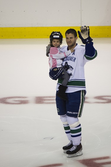 Vancouver Canucks Kevin Bieksa takes to the ice with his daughter before he competes in the annual Super Skills Competition on Saturday at Rogers Arena in Vancouver. January 11, 2014 .