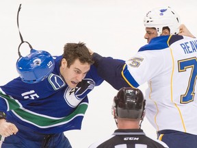 Former Canucks winger Aaron Volpatti trades shots with then-St.  Louis Blues tough guy Ryan Reaves in a February 2013 NHL game at Rogers Arena.