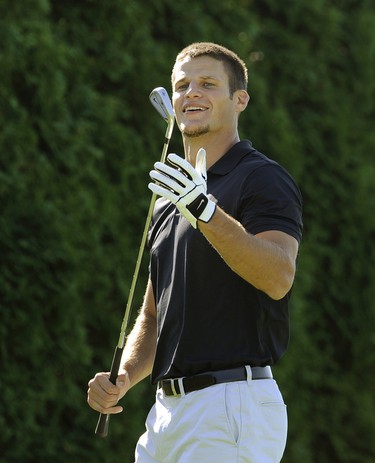 Vancouver Canucks Kevin Bieksa, in action at Mayfair Lakes golf course along with (former player ) at the   charity golf tournament in Rick Rypien's honour on  September  4, 2012 in Richmond B.C.