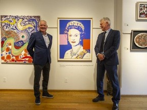 David and Robert Heffel stand beside an Andy Warhol silkscreen print of Queen Elizabeth at their gallery at Granville and 7th in Vancouver.