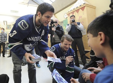 Canucks' Kevin Bieksa and Derek Dorset  meet with sick children at the BC Childrens Hospital in Vancouver, BC., December 11, 2014.  (Nick Procaylo/PNG)