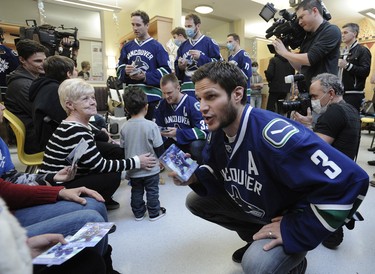 Canucks' Kevin Bieksa  meets with sick children at the BC Childrens Hospital in Vancouver, BC., December 11, 2014.  (Nick Procaylo/PNG)