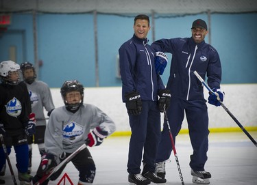 NHL players Kevin Bieksa and Jason Garrison, (r) two former Canucks defencemen have some fun with kids as they assist in hockey school program in Richmond, where they also train the upcoming season.    Mark van Manen/ PNG
