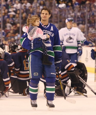 Kevin Bieksa parades his daughter on the ice during the skills competition. The Vancouver Canucks hold their annual Canucks for Kids Fund SuperSkills competition in 2013.