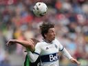 Vancouver Whitecaps' Ryan Gauld, front right, and Austin FC's Alexander Ring vie for the ball during the first half of an MLS soccer game in Vancouver, on Saturday, Oct. 1, 2022.