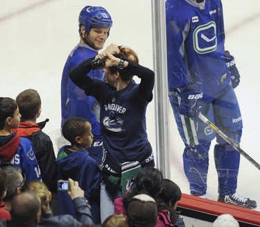 The Vancouver Canucks took to the ice Saturday morning March 22, 2014 at Rogers Arena in front of several thousand fans for their annual open practice. Pictured is Kevin Bieksa reacting to a fan wearing a Bieksa jersey.  (Photo by Jason Payne/ PNG)