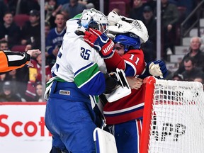 Thatcher Demko #35 of the Vancouver Canucks and Brendan Gallagher #11 of the Montreal Canadiens rough each other up during the second period at Centre Bell on November 9, 2022 in Montreal, Quebec, Canada.
