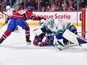 Thatcher Demko of the Vancouver Canucks shows his frustration against Brendan Gallagher of the Montreal Canadiens during the second period at Centre Bell on November 9, 2022 in Montreal, Quebec, Canada.