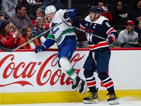 Alex Ovechkin of the Washington Capitals, who is always their most dangerous player, gives Canucks forward Curtis Lazar (left) a rough ride along the boards during their game last month in Washington, D.C.