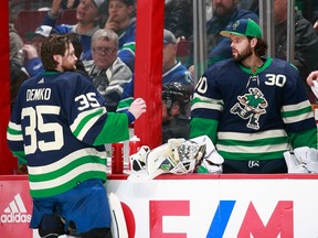 Thatcher Demko of the Vancouver Canucks speaks with teammate Spencer Martin during an NHL game against the New Jersey Devils at Rogers Arena Nov. 1, 2022.