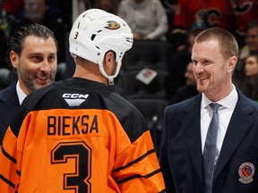 From left, Roberto Luongo, Kevin Bieksa, and Henrik Sedin chat before the Hockey Hall of Fame Legends Classic game at Scotiabank Arena in Toronto on Sunday, November 13, 2022.