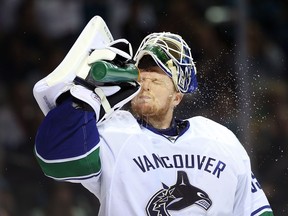 Goaltender Cory Schneider sprays water in his face in Game Four of the Western Conference Quarterfinals against the San Jose Sharks during the 2013 NHL Stanley Cup Playoffs at HP Pavilion on May 7, 2013 in San Jose. The Sharks defeated the Canucks 4-3 to sweep the series 4 games to 0.
