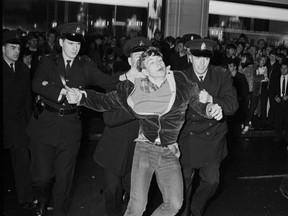 Young man being arrested at the Grey Cup riot on Nov. 25, 1966.