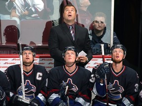 Then-head coach Alain Vigneault looks up behind his trio of super Swedes — captain Markus Naslund, Daniel Sedin and Henrik Sedin (left to right) — during a September 2006 pre-season game (Vigneault’s rookie campaign as Canucks coach) at GM Place.