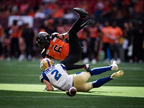 B.C. Lions' T.J. Lee (6) collides with Winnipeg Blue Bombers' Greg Ellingson (2) after preventing him from making a reception during a CFL game in Vancouver on July 9.