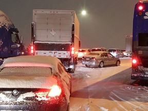 Dozens of vehicles were stranded on the Northbound lanes of the Alex Fraser bridge for several hours due to accumulating snow on Tuesday, Nov. 29, 2022. Crews worked to plow and salt the bridge deck including several transit busses and semi-trucks.