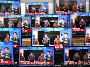 Television screens show a news report about the latest North Korean missile launch with file footage of North Korean leader Kim Jong Un, at an electronic market in Seoul on November 3, 2022.