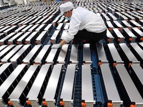 A worker looks over car batteries at a factory in Nanjing, China.