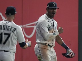 Seattle Mariners centre fielder Julio Rodriguez, right, celebrates after making a catch for an out against the Houston Astros, during the 16 inning in Game 3 of an American League Division Series baseball game Saturday, Oct. 15, 2022, in Seattle.