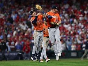 Houston Astros third baseman Alex Bregman (2) and designated hitter Trey Mancini (26)  reacts after the ninth inning against the Philadelphia Phillies in game five of the 2022 World Series at Citizens Bank Park.