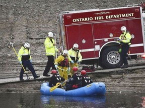 A swift water rescue team from the Ontario Fire Dept. rides in a raft on flood waters in a flood control channel in Ontario, Calif. on Tuesday, Nov. 8, 2022.
