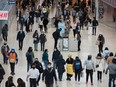 People navigate through Yorkdale Mall in search of Black Friday sales in Toronto on Nov. 26, 2021.