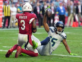 Seattle Seahawks wide receiver Tyler Lockett (16) catches a touchdown pass against Arizona Cardinals safety Budda Baker (3) during the second half at State Farm Stadium.