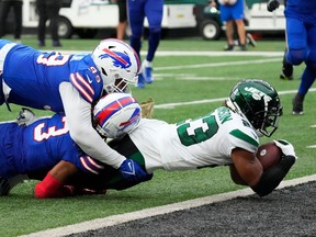 New York Jets running back James Robinson (23) scores a 4th quarter touchdown against the Bills at MetLife Stadium.