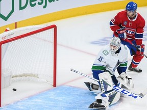 Vancouver Canucks goaltender Thatcher Demko takes on Nick Suzuki of the Montreal Canadiens as Sean Monaghan, 91, of the Canadiens looks on during NHL hockey action of the first period in Montreal, Wednesday, November 9, 2022. (not shown).